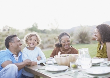 Multi-Generational Family Eating at Table Outside